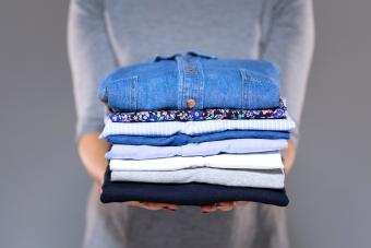 Woman holding clothes in hands