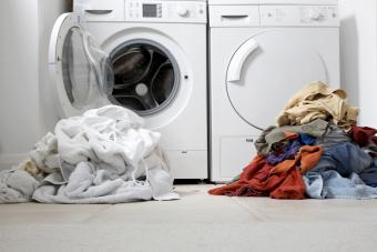 One coloured pile of clothes and another one of white clothes for washing