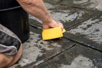 man scrubbing pavers