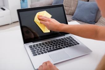 Woman Hand Cleaning Laptop Screen 