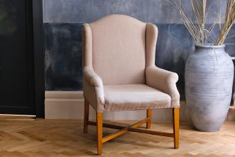 beige chair and a large vase on the floor