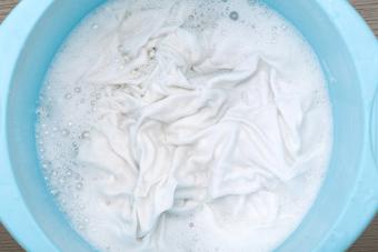 Soaking clothes in a blue basin