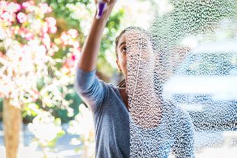 Woman cleaning the window