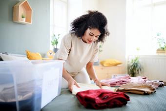 Young woman sorting wardrobe