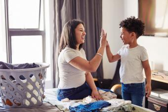 Mom and son cleaning room together