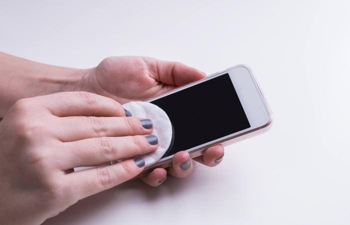 Woman cleaning mobile phone