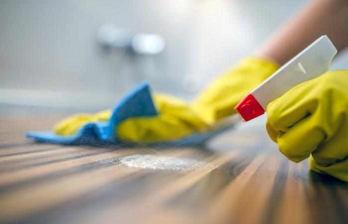 Cleaning kitchen table with blue cloth