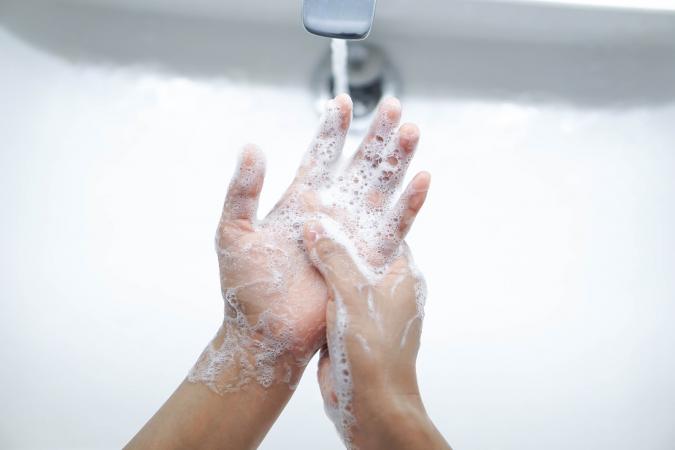 Person washing hands with soap