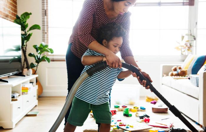 Son helping clean the room
