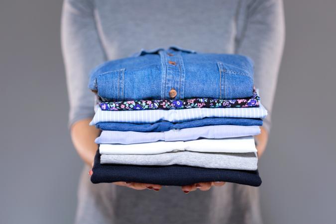 Woman holding clothes in hands