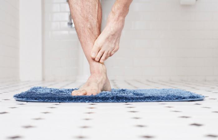 Man standing on bathmat
