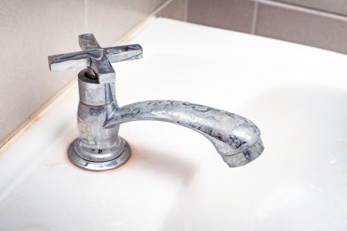 Dirty faucet with hard water deposits