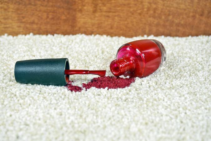 Spilled red nail polish on carpet