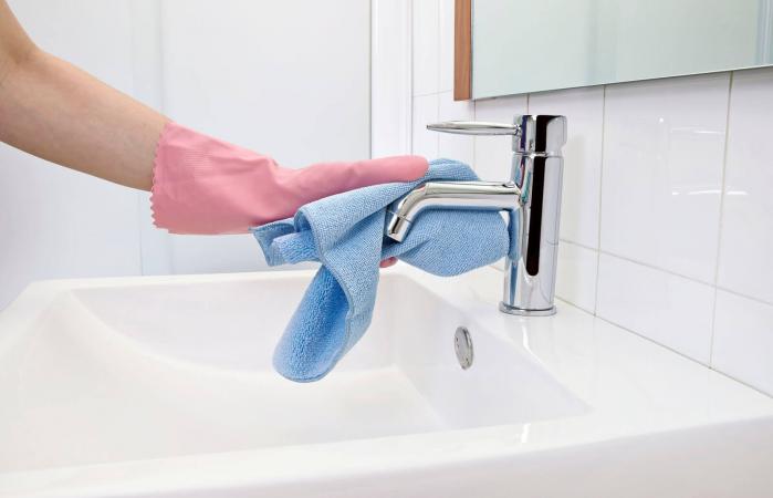 woman cleaning chrome