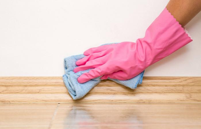 Hand cleaning baseboard