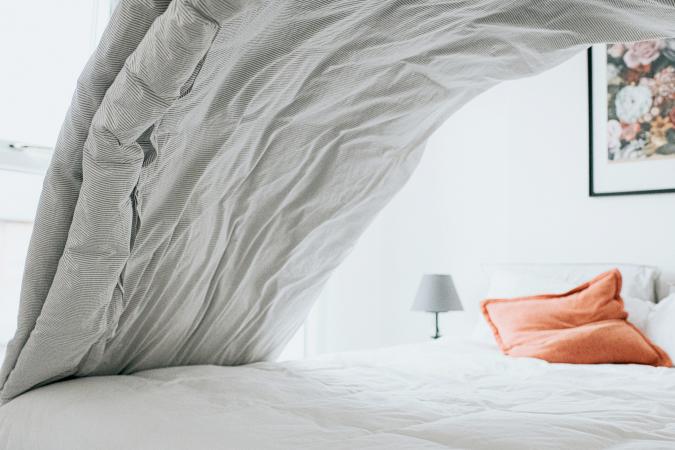 Making the bed with clean comforters