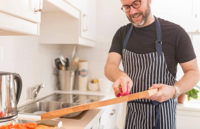 Man cleaning cutting board
