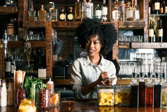 Bartender working behind bar in pub