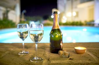 Two glasses of prosecco a the poolside by night