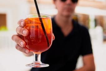 man holding cocktail with carbonation