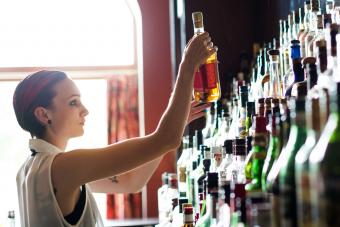 bartender selecting liquor bottle