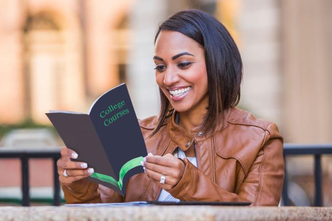 Student reading college courses booklet