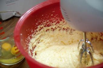 A bowl of cake batter in a mixer.