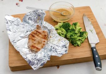 Foil-grilled pork chop and fresh broccoli