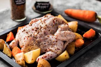 Still life full length raw chicken for roasting preparation