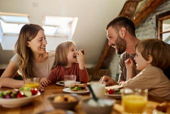  Young family talking during breakfast at dining table