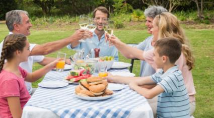 Family toasting at dinner outside
