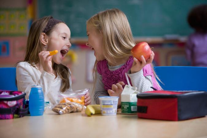 Girls having a healthy lunch at school