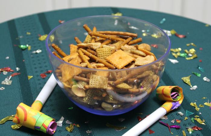 Bowl of Chex party mix and party blowers