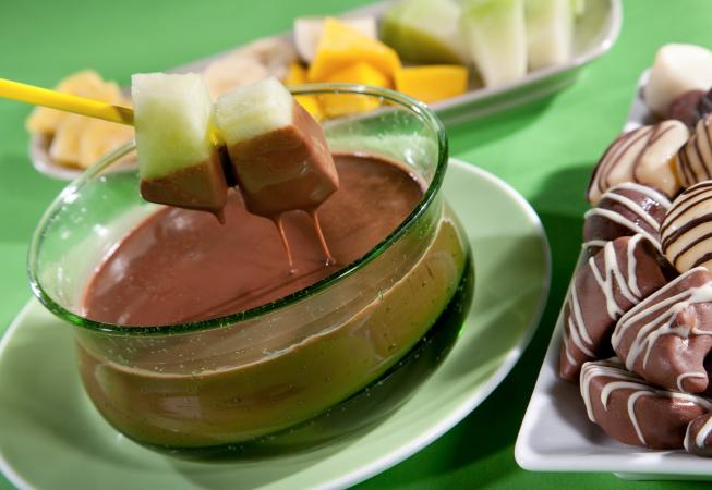 Fresh Fruit Being Dipped In Chocolate