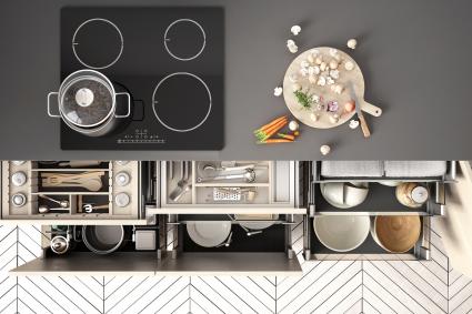 Modern kitchen top view, opened drawers and stove with cooking pan