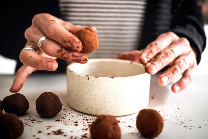 Person rolling truffles in chocolate