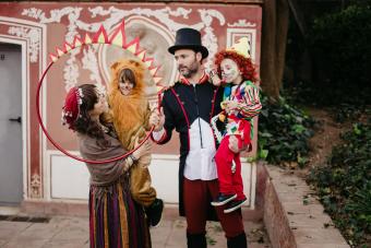 Family of four dressed as the circus playing