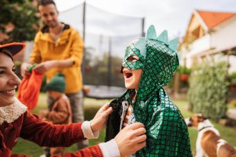 boy getting ready for the Halloween party with his mom