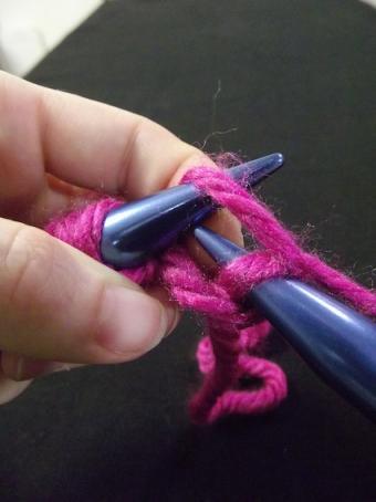Step six of knitting a knit stitch
