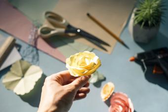 Female hand holding a paper rose