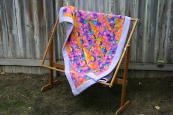 Small unfinished quilt on a frame.