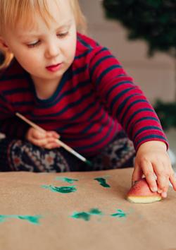 Girl stamping on brown paper