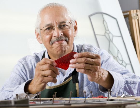 Craftsperson working on stained glass pattern
