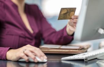 Businesswoman holding card at desk in office