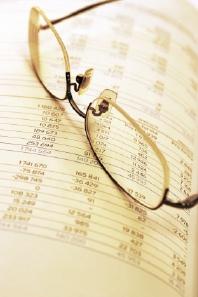 Glasses laying on a financial report