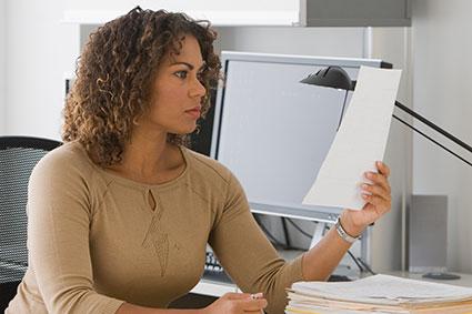 woman looking at credit report