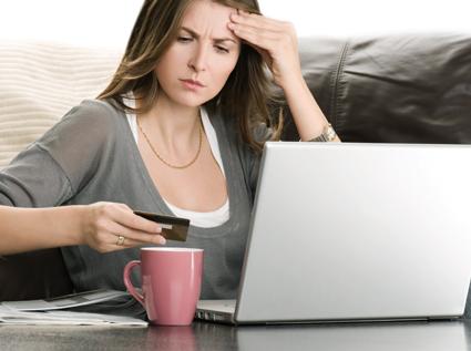 Woman looking at credit card
