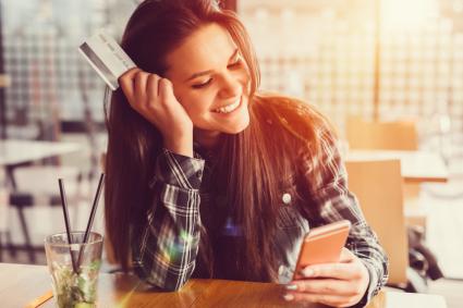 Girl holding credit card and texting