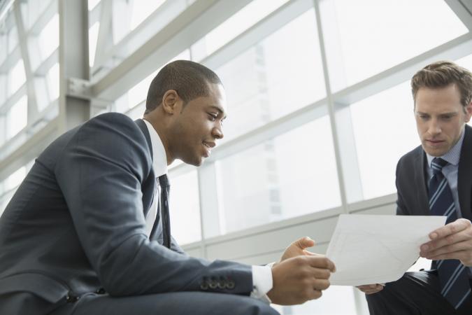 Businessmen discussing letter