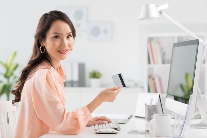 Woman using credit card online
